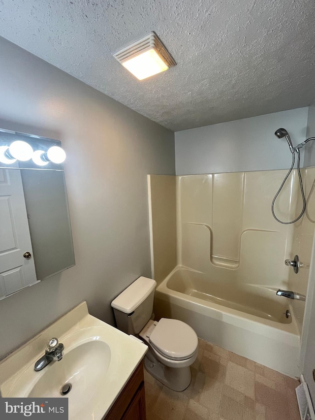 bathroom featuring toilet, tub / shower combination, a textured ceiling, vanity, and tile patterned floors