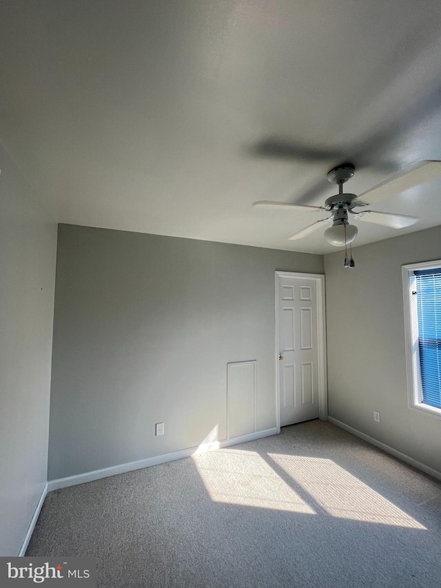 unfurnished bedroom with carpet floors, ceiling fan, and baseboards