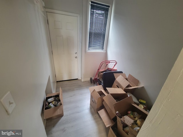 interior space featuring light wood-type flooring and baseboards