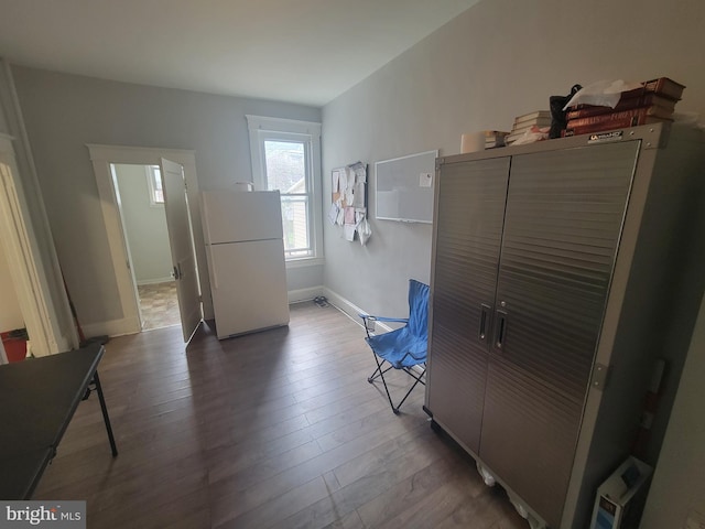 interior space featuring wood finished floors and baseboards