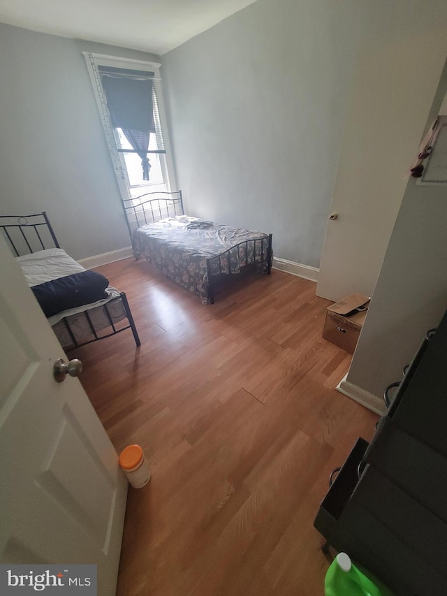 bedroom featuring light wood-style flooring and baseboards