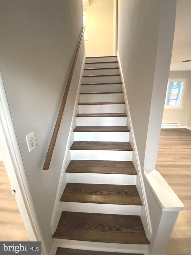 staircase with a baseboard radiator