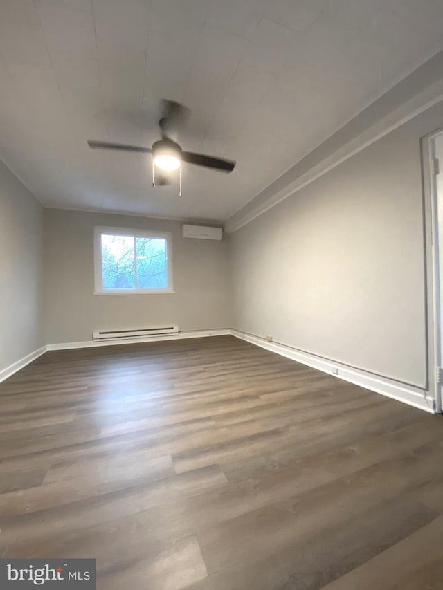 spare room with ceiling fan, a baseboard heating unit, dark hardwood / wood-style flooring, and an AC wall unit