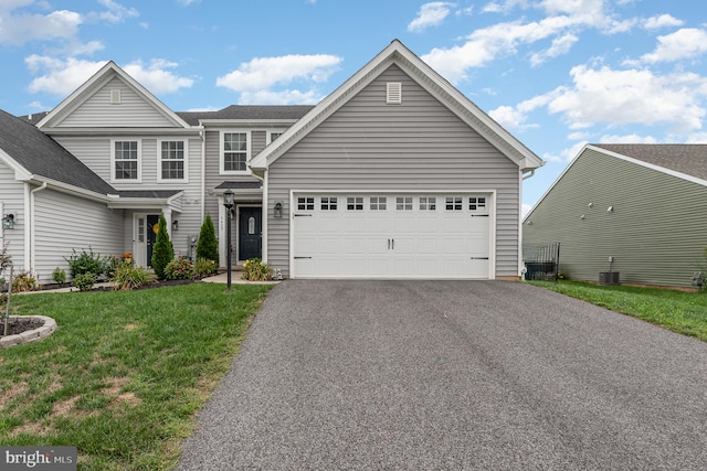 view of front of property featuring a front lawn and a garage