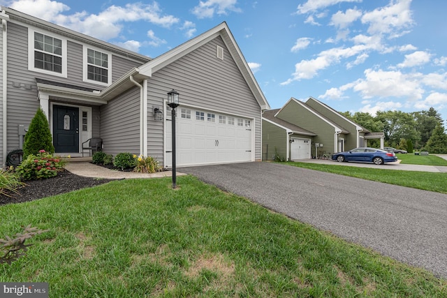 view of front of house with a garage and a front lawn