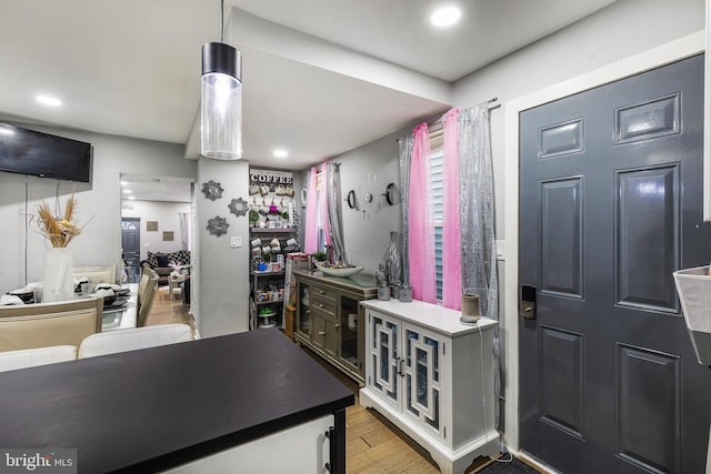 kitchen with hardwood / wood-style flooring and pendant lighting