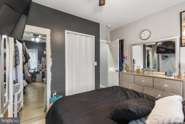 bedroom with ceiling fan and wood-type flooring