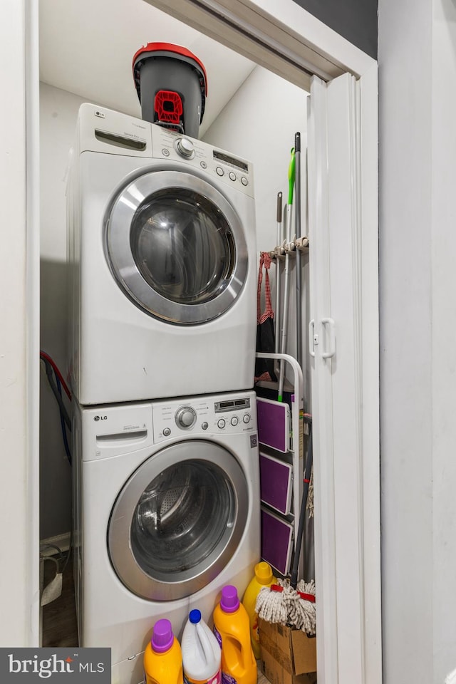 laundry room featuring stacked washing maching and dryer