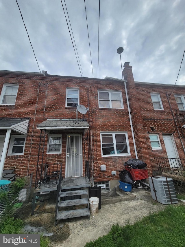 back of house featuring central AC unit