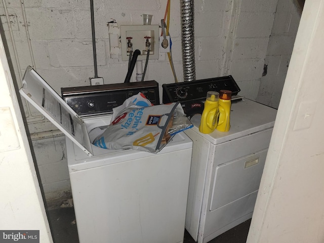 clothes washing area featuring washer and dryer