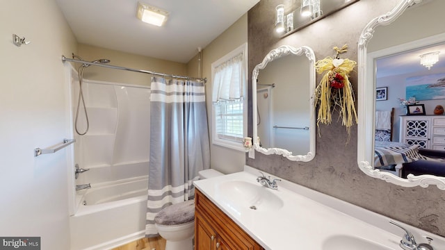 full bathroom featuring hardwood / wood-style floors, toilet, shower / tub combo with curtain, and vanity