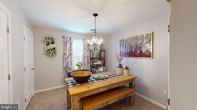 carpeted dining area featuring a notable chandelier