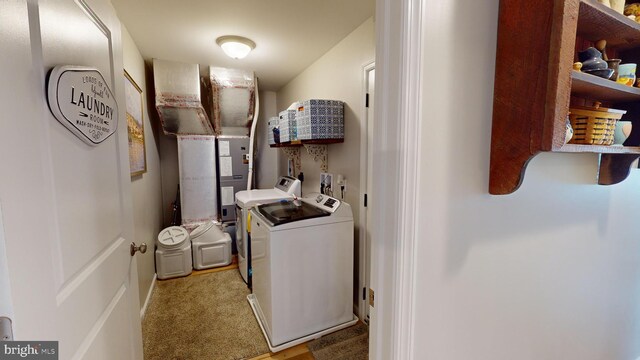 washroom featuring washing machine and dryer and light carpet