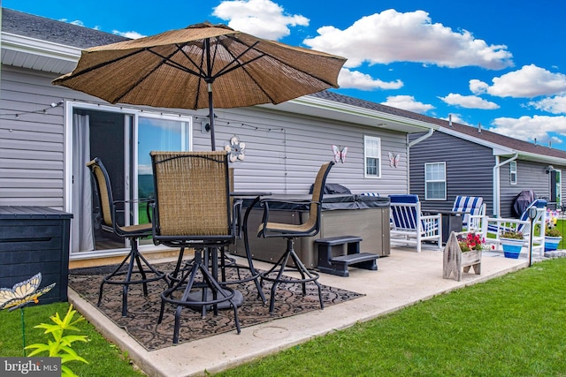 view of patio / terrace with a hot tub