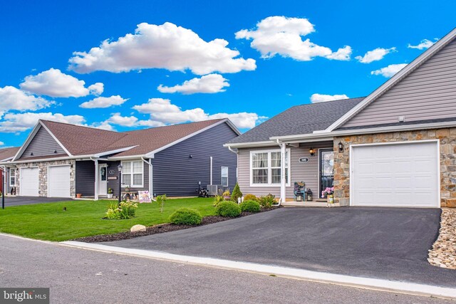 ranch-style house featuring a front lawn and a garage