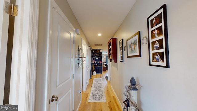 corridor with recessed lighting and light wood finished floors