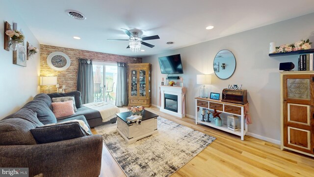 living room with ceiling fan and light hardwood / wood-style floors