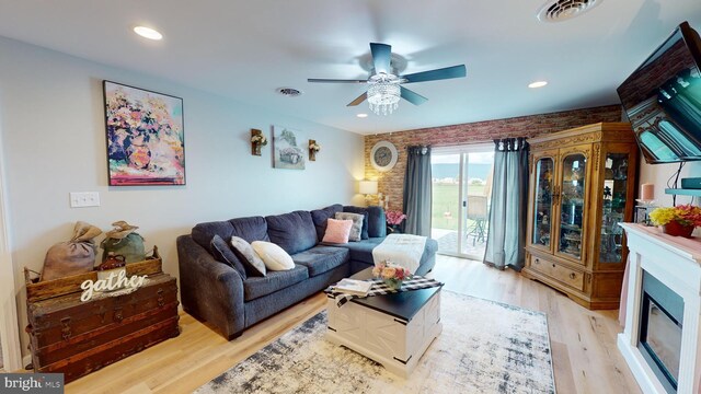 living room featuring light hardwood / wood-style floors and ceiling fan