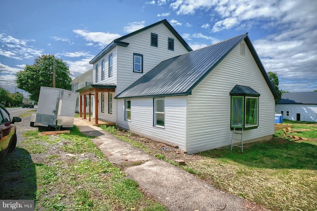 view of side of property with a lawn