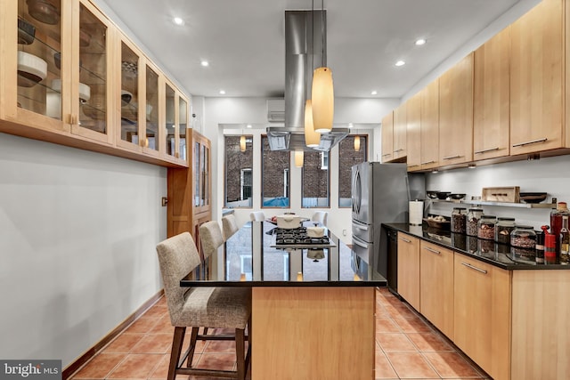 kitchen with light tile patterned floors, light brown cabinets, a kitchen breakfast bar, pendant lighting, and a kitchen island