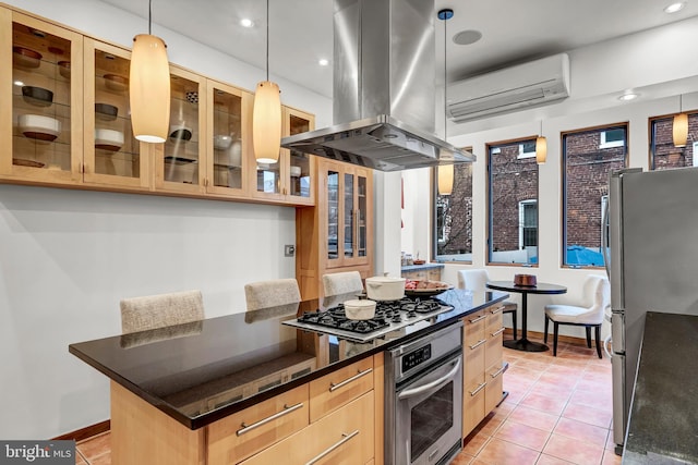 kitchen with a wall mounted AC, stainless steel appliances, light brown cabinetry, a center island, and island exhaust hood