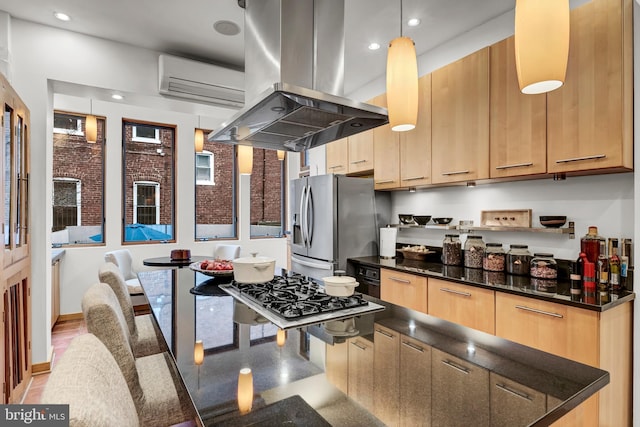 kitchen featuring stainless steel fridge with ice dispenser, island exhaust hood, dark stone countertops, and hanging light fixtures