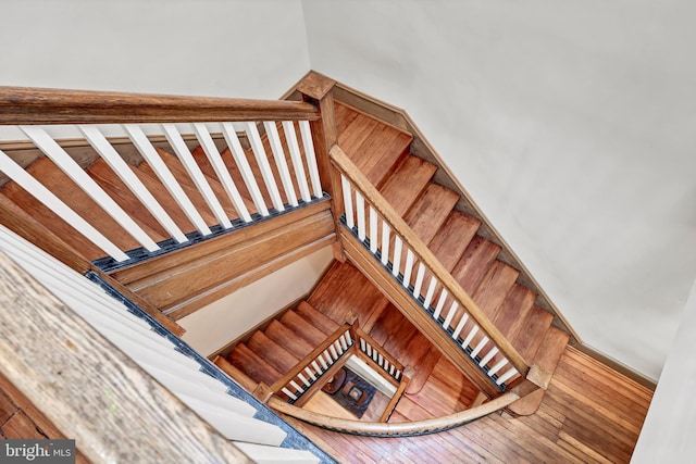 staircase with wood-type flooring