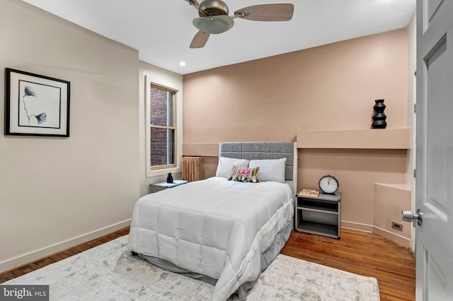 bedroom with ceiling fan and dark hardwood / wood-style flooring