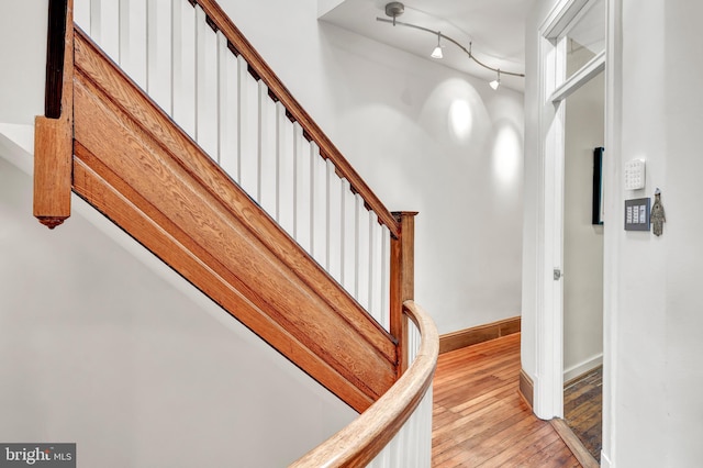 interior space featuring track lighting and wood-type flooring