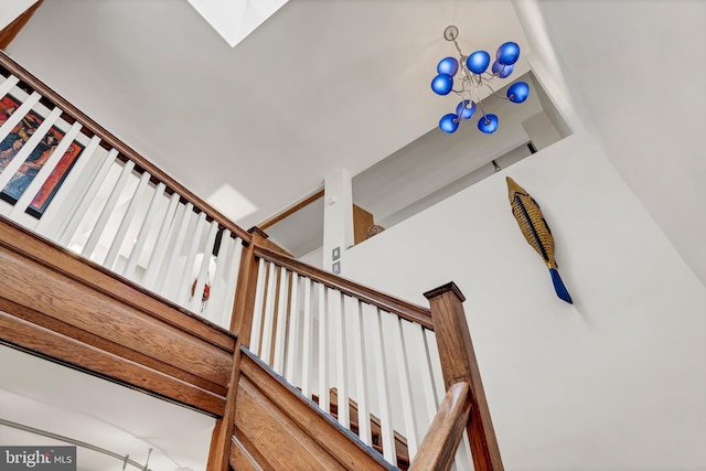 staircase featuring a towering ceiling