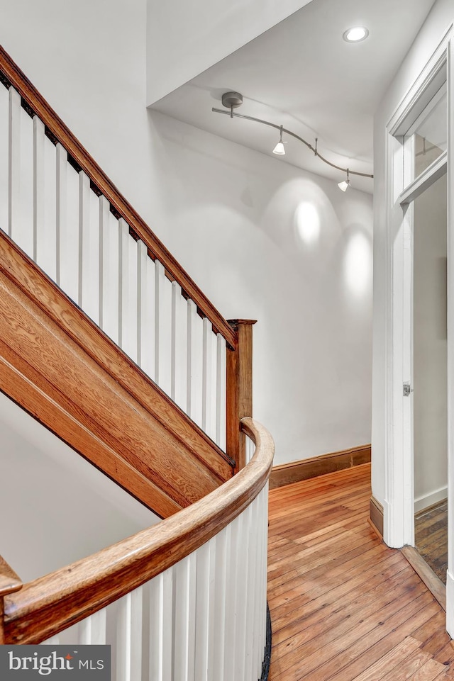 stairs featuring wood-type flooring