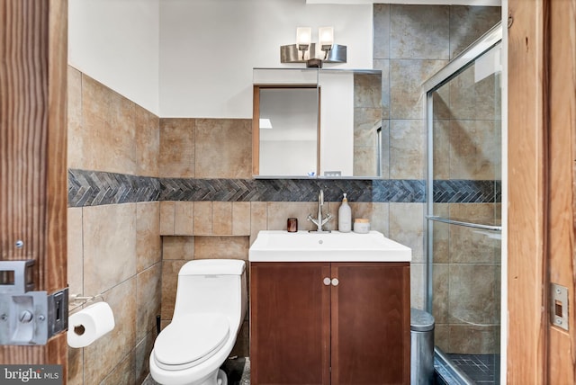 bathroom featuring tile walls and toilet