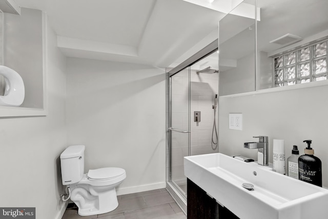 bathroom featuring tile patterned flooring, walk in shower, toilet, and vanity