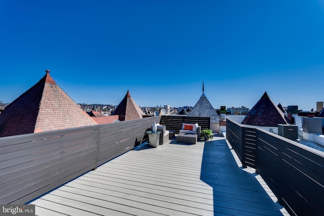 wooden deck with central air condition unit and an outdoor hangout area