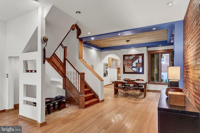 interior space featuring brick wall and light hardwood / wood-style floors