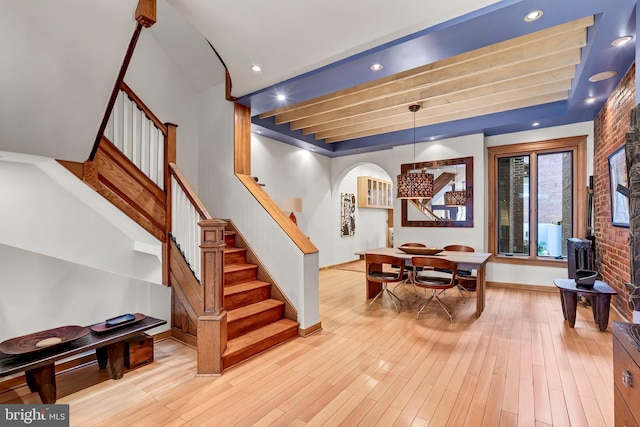 entrance foyer featuring light wood-type flooring and brick wall