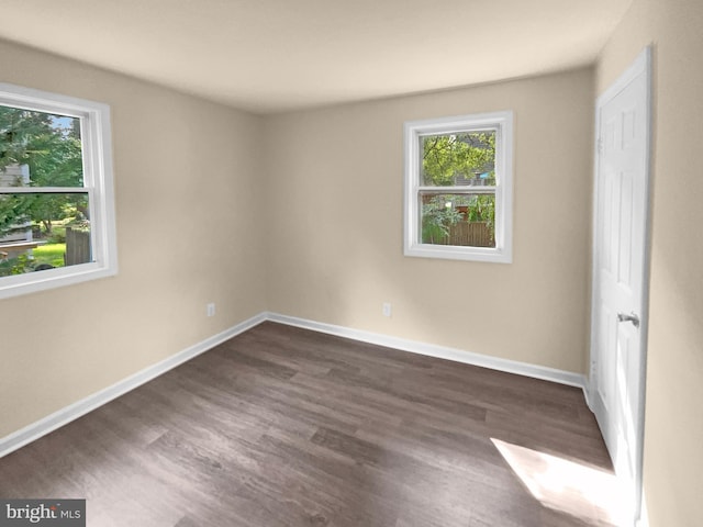 unfurnished bedroom with dark wood-style floors and baseboards