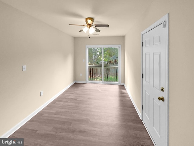 empty room featuring a ceiling fan, baseboards, and wood finished floors