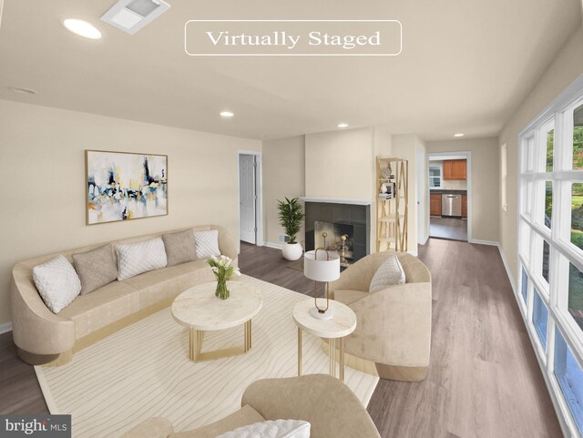 kitchen with sink, high vaulted ceiling, hardwood / wood-style floors, and stainless steel appliances