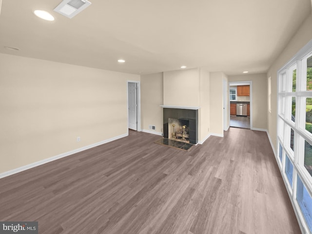 unfurnished living room featuring hardwood / wood-style floors and a fireplace