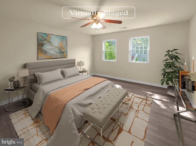 bedroom featuring visible vents, baseboards, ceiling fan, and wood finished floors