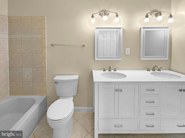 full bathroom with tile patterned flooring, toilet, tiled shower / bath combo, and dual bowl vanity