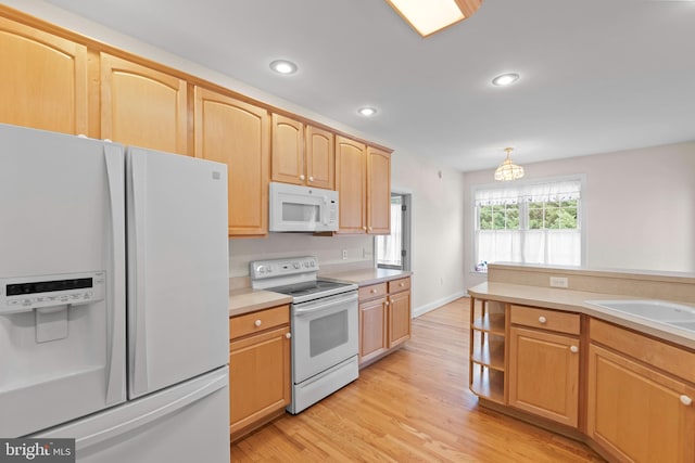 kitchen featuring white appliances, light hardwood / wood-style floors, light brown cabinetry, and sink