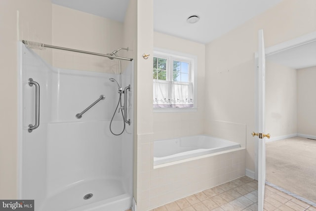 bathroom featuring plus walk in shower and tile patterned floors