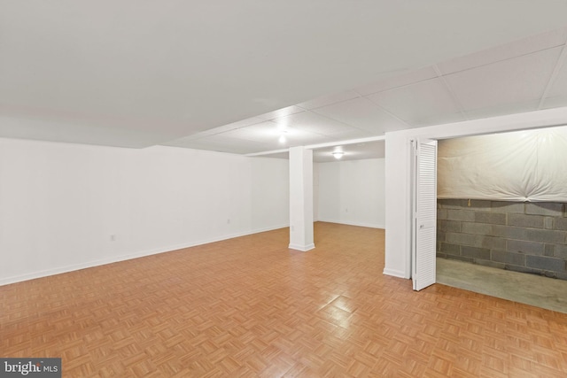 basement featuring light parquet flooring