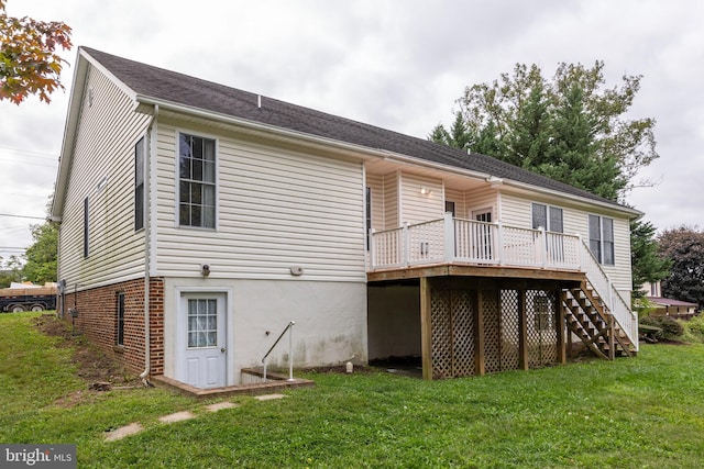 back of property featuring a lawn and a deck