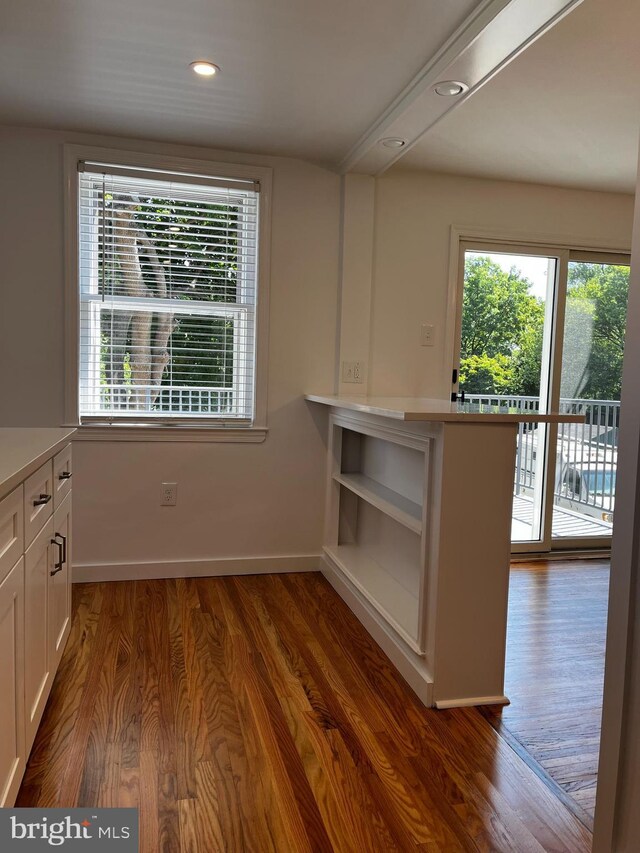 kitchen with white cabinets and hardwood / wood-style floors