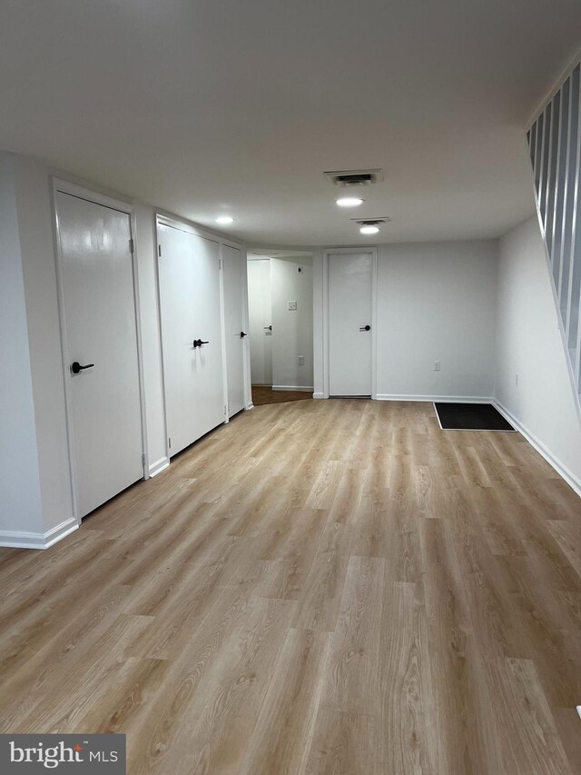 basement with light hardwood / wood-style floors