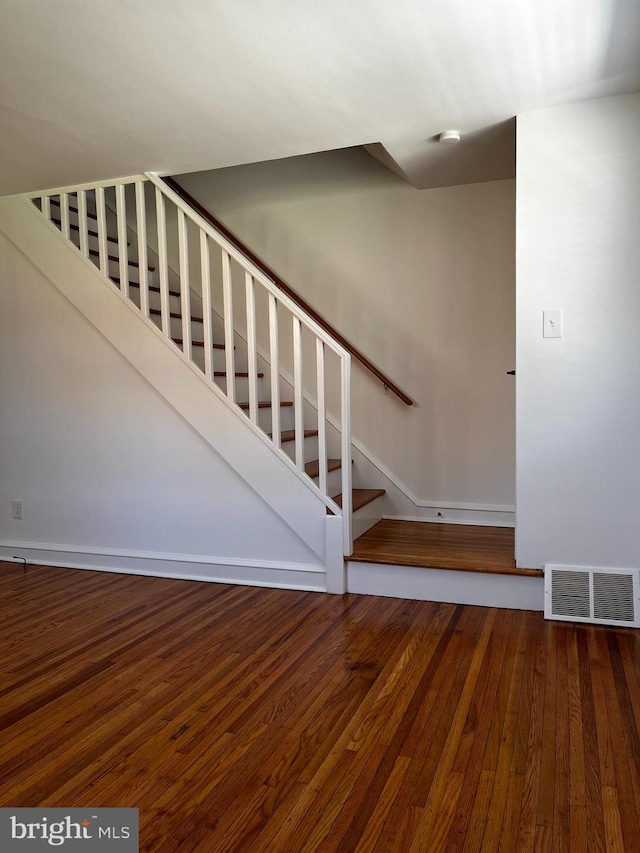 stairway with hardwood / wood-style flooring