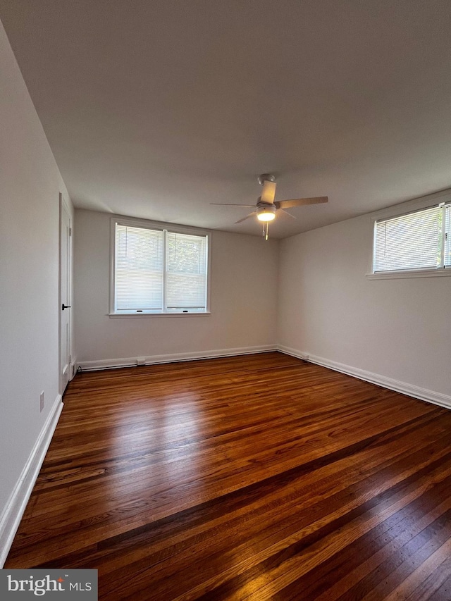 empty room with hardwood / wood-style flooring and ceiling fan